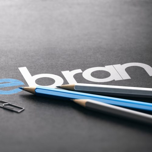 Word rebrand with the prefix re handwritten over black paper background, Marketing and brand management concept. 3D illustration